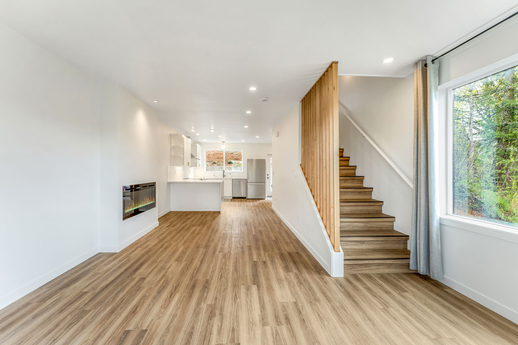 SW Portland Remodeler for Townhome shows LVP Stair upon entering the home